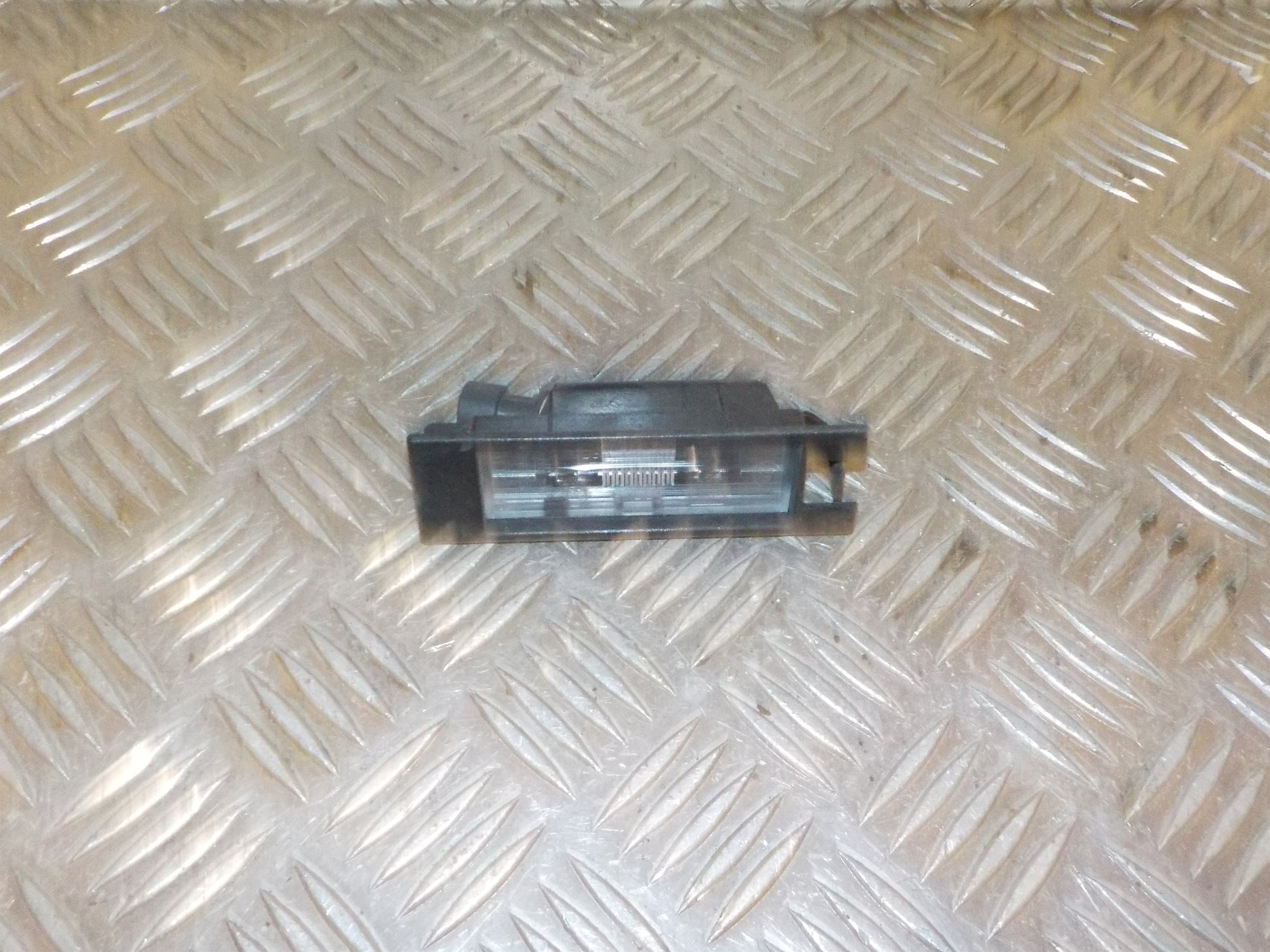 Opel Corsa E Nummerpladelygte Med OEM Nr. 	13251936 Fra Opel Ophugger